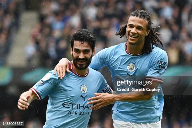 Ilkay Guendogan of Manchester City celebrates with team mate Nathan Ake after scoring their sides second goal during the Premier League match between...