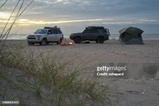 overland camping on the beach with 4runners at sunrise - cape lookout national seashore stock pictures, royalty-free photos & images