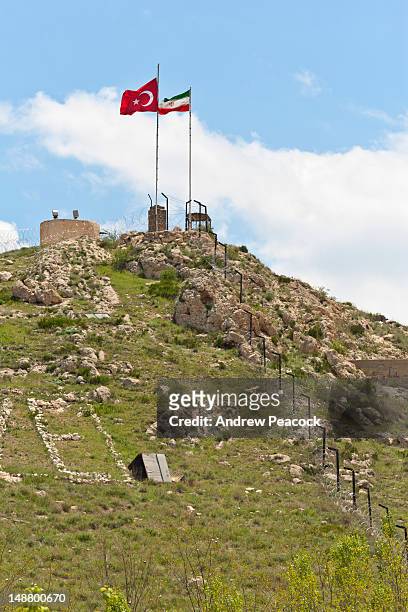 national flags at turkey-iran border crossing to bazargan. - turkey middle east stock pictures, royalty-free photos & images