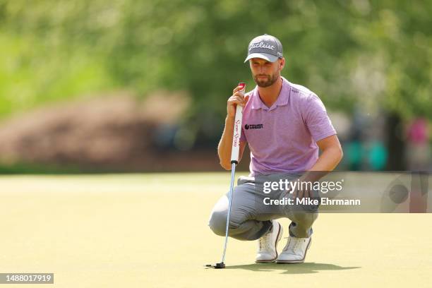 Wyndham Clark of the United States lines up a putt on the 13th green during the third round of the Wells Fargo Championship at Quail Hollow Country...
