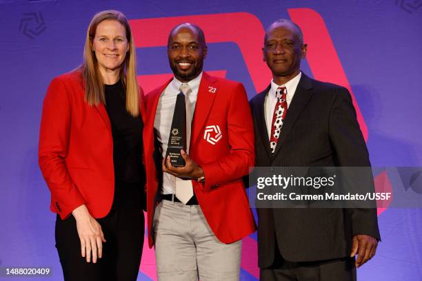 DaMarcus Beasley stands with Cynthia Parlow Cone and Henry Beasley after being inducted into the National Soccer Hall of Fame at Toyota Stadium on...