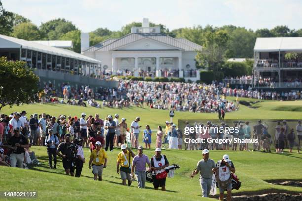 Wyndham Clark of the United States and Xander Schauffele of the United States walk on the 17th hole during the third round of the Wells Fargo...