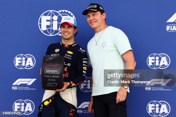 Pole position qualifier Sergio Perez of Mexico and Oracle Red Bull Racing is presented with the Pirelli Pole Position award by Tiesto in parc ferme...
