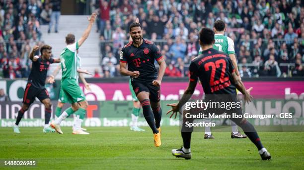 Serge Gnabry of Munich celebrates with Joao Cancelo of Munich after scoring his team's first goal during the Bundesliga match between SV Werder...