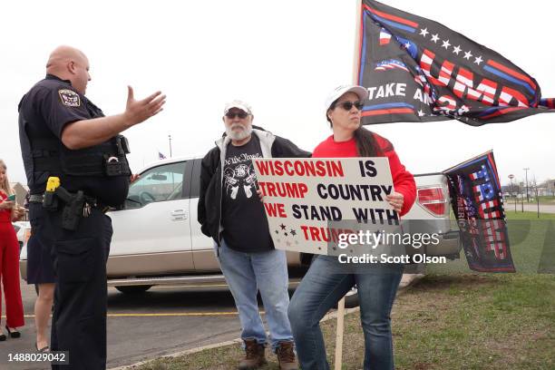 Police officer asks Trump supporters demonstrating outside of the Central Wisconsin Convention and Expo Center where the Republican Party of Marathon...