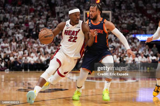 Jimmy Butler of the Miami Heat drives past Jalen Brunson of the New York Knicks during game three of the Eastern Conference Semifinals at Kaseya...