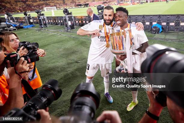 Vinicius Junior and Karim Benzema of Real Madrid pose with the trophy after the Copa del Rey Final match between Real Madrid CF and CA Osasuna at...