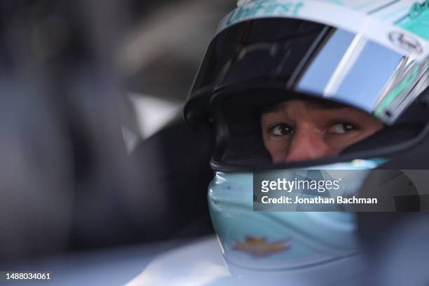 Chase Elliott, driver of the UniFirst Chevrolet, sits in his car during qualifying for the NASCAR Cup Series Advent Health 400 at Kansas Speedway on...