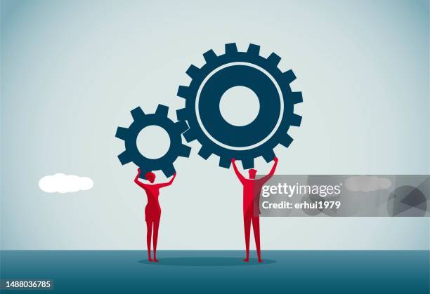 zwei personen, die zahnräder halten - hochhalten stock-grafiken, -clipart, -cartoons und -symbole