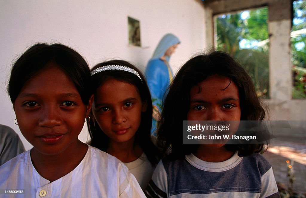 Children in the burnt out church, Dili.