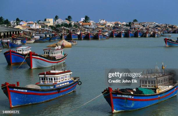 a fleet of fishing boats docked at the harbour in nha trang - nha trang stock pictures, royalty-free photos & images