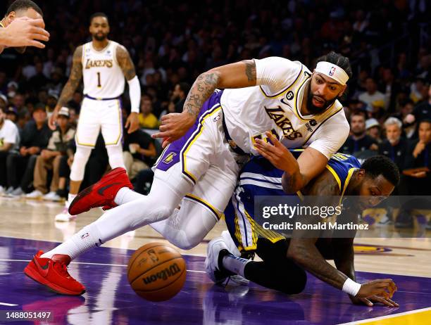 Anthony Davis of the Los Angeles Lakers falls over JaMychal Green of the Golden State Warriors watching the ball in game three of the Western...