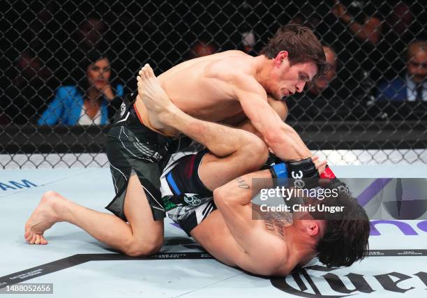 Movsar Evloev of Russia punches Diego Lopes of Brazil in a featherweight fight during the UFC 288 event at Prudential Center on May 06, 2023 in...