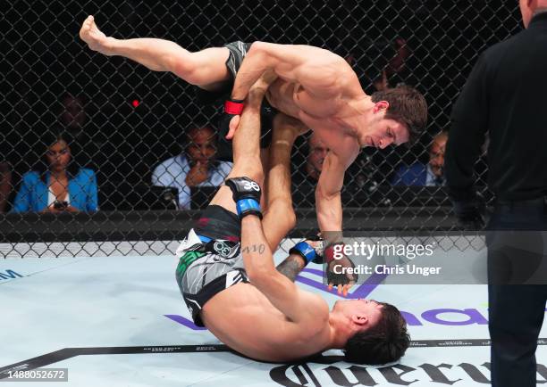 Diego Lopes of Brazil attempts to sweep Movsar Evloev of Russia in a featherweight fight during the UFC 288 event at Prudential Center on May 06,...