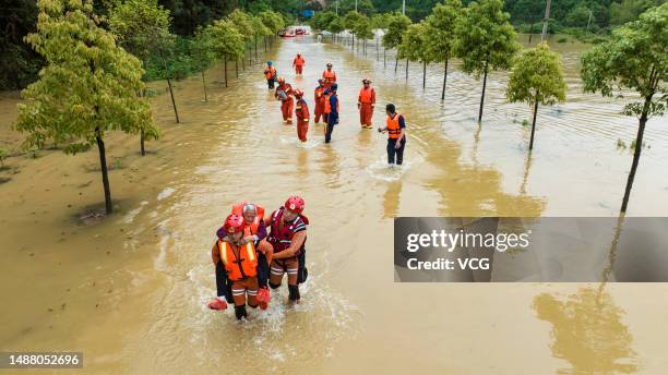Rescuers evacuate residents from a flood-hit area after torrential rains on May 6, 2023 in Xingan County, Ji'an City, Jiangxi Province of China....