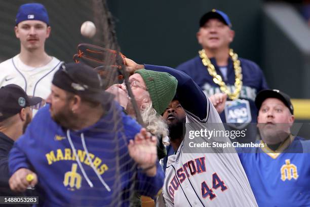 Yordan Alvarez of the Houston Astros makes a catch in foul territory for an out against Ty France of the Seattle Mariners during the fifth inning at...