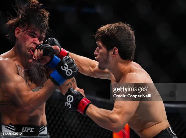 Movsar Evloev of Russia punches Diego Lopes of Brazil in a featherweight fight during the UFC 288 event at Prudential Center on May 06, 2023 in...