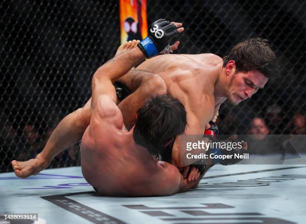 Movsar Evloev of Russia elbows Diego Lopes of Brazil in a featherweight fight during the UFC 288 event at Prudential Center on May 06, 2023 in...