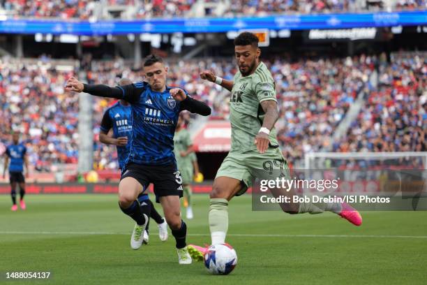 Denis Bouanga of LAFC strikes the ball under pressure from Paul Marie of the San Jose Earthquakes during a game between San Jose Earthquakes and Los...