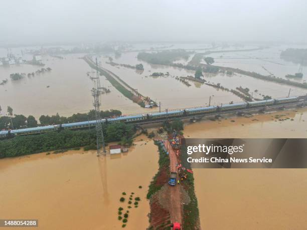 Aerial view of rescuers working to block a dyke breach after torrential rains on May 6, 2023 in Fengcheng, Yichun City, Jiangxi Province of China....