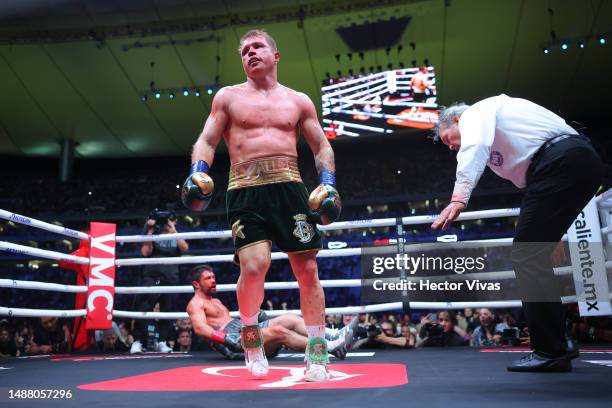 Canelo Alvarez of Mexico reacts as John Ryder of Great Britain lies on the canvas during the fight for the Super Middleweight Championship at Akron...