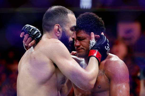 Belal Muhammad embraces Gilbert Burns of Brazil after their welterweight bout at UFC 288 at Prudential Center on May 06, 2023 in Newark, New Jersey....