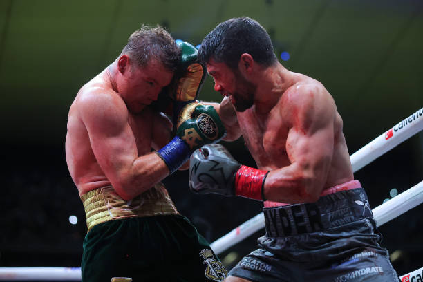 John Ryder of Great Britain punches Canelo Alvarez of Mexico during the fight for the Super Middleweight Championship at Akron Stadium on May 06,...