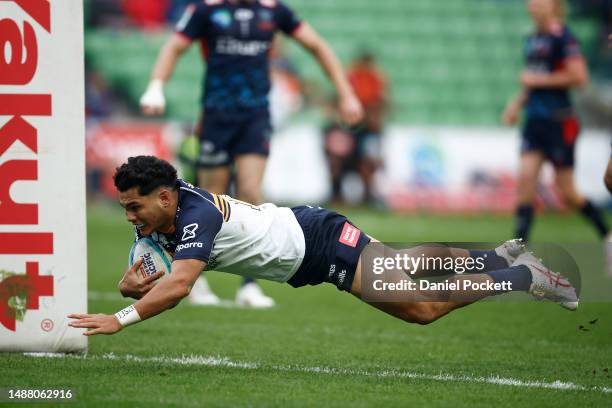 Noah Lolesio of the Brumbies scores a try during the round 11 Super Rugby Pacific match between Melbourne Rebels and ACT Brumbies at AAMI Park, on...