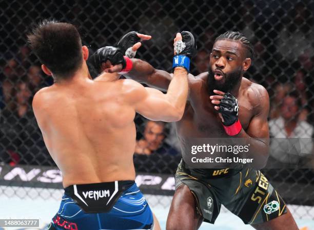 Aljamain Sterling punches Henry Cejudo in the UFC bantamweight championship fight during the UFC 288 event at Prudential Center on May 06, 2023 in...