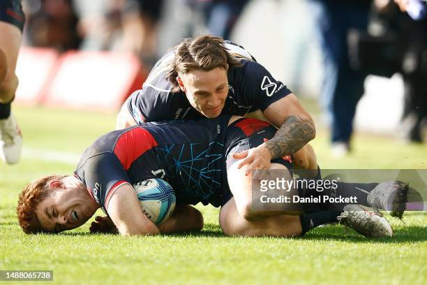 Andrew Kellaway of the Rebels is tackled by Corey Toole of the Brumbies during the round 11 Super Rugby Pacific match between Melbourne Rebels and...