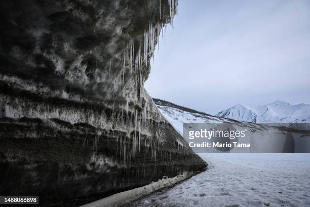 Icicles hang in an ice cave created by meltwater at the retreating Castner Glacier in the Alaska Range on May 5, 2023 near Paxson, Alaska. The ice...