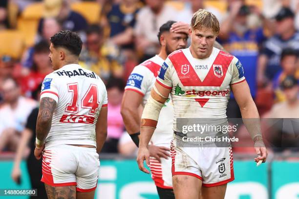 Jack de Belin of the Dragons assists Jayden Sullivan of the Dragons after losing the round 10 NRL match between Wests Tigers and St George Illawarra...