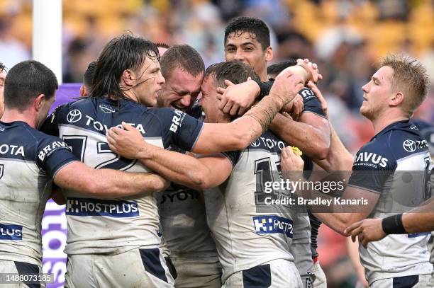 Reuben Cotter of the Cowboys is congratulated by team mates after scoring a try during the round 10 NRL match between Sydney Roosters and North...