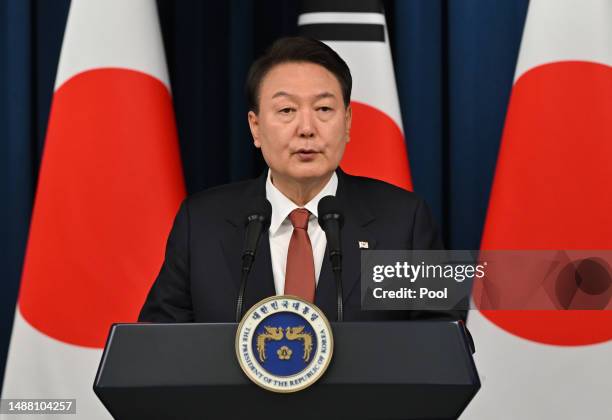 South Korean President Yoon Suk Yeol speaks during a joint press conference with Japanese Prime Minister Fumio Kishida after their meeting at the...