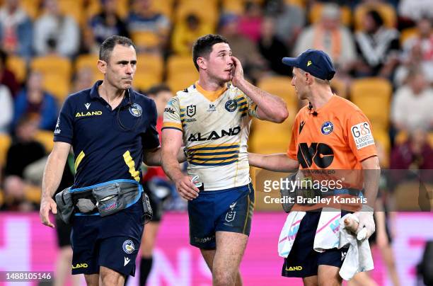 Mitchell Moses of the Eels is taken from the field for a HIA exam during the round 10 NRL match between Gold Coast Titans and Parramatta Eels at...