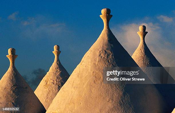 white-washed trulli roofs. - trulli stockfoto's en -beelden