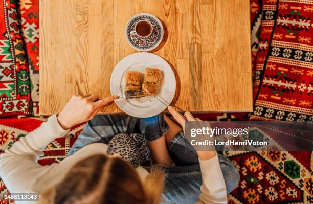 woman eating traditional turkish delight baklava - turkish delight stock pictures, royalty-free photos & images