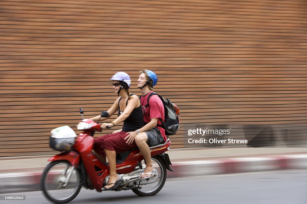 Tourists on motorbike.