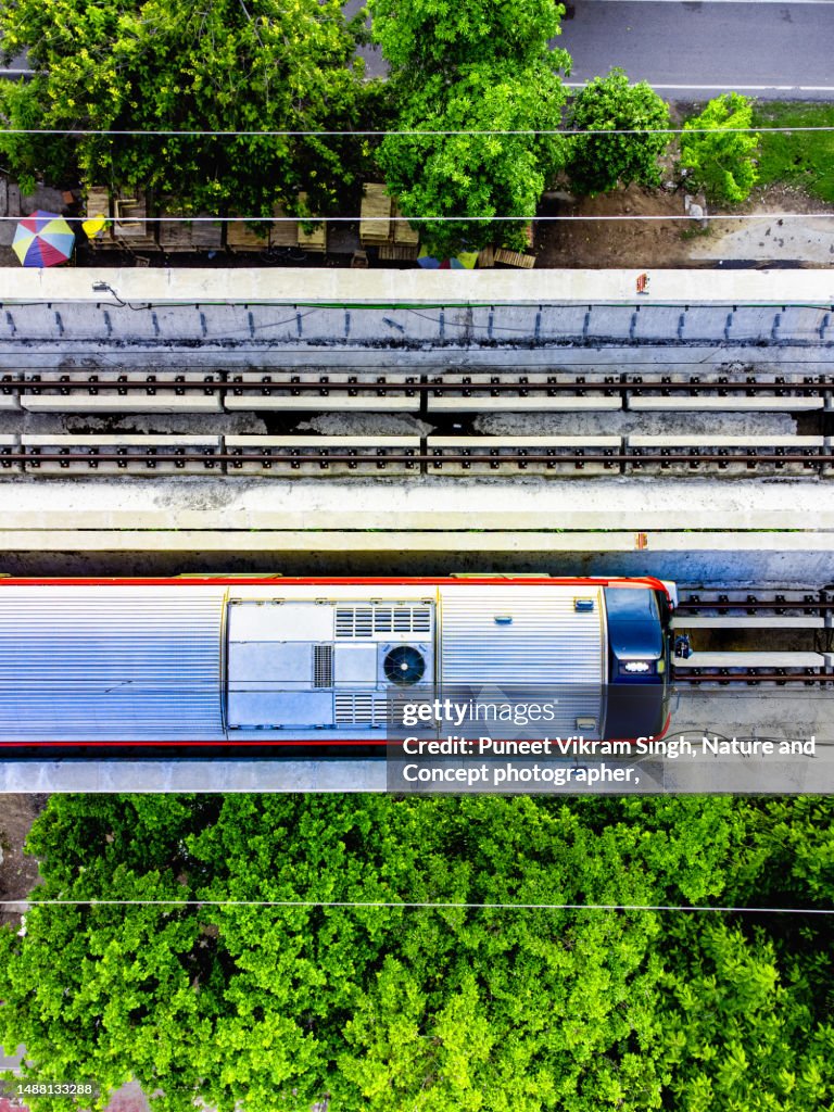 Conceptual shot of a Metro train depicting -Go Green and earn Carbon Credits by using renewable energy resources and reduce carbon footprint by avoiding fossil fuel based public transports