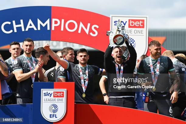 Steven Schumacher, Manager of Plymouth Argyle, lifts the Sky Bet League One trophy with teammates after victory against Port Vale in the Sky Bet...