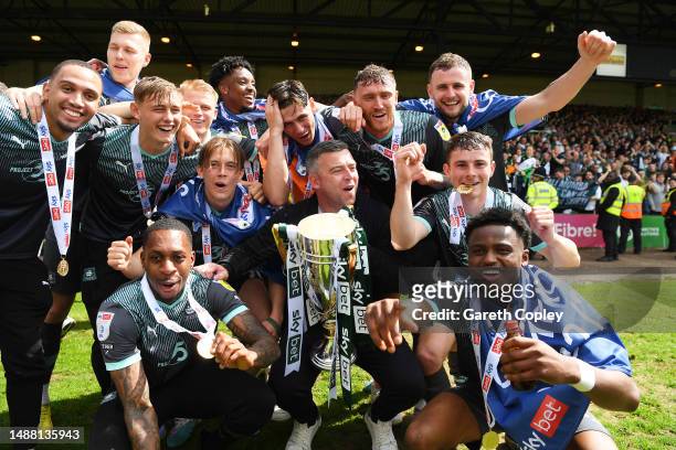 Steven Schumacher, Manager of Plymouth Argyle, celebrates while holding the Sky Bet League One trophy with his players after victory against Port...