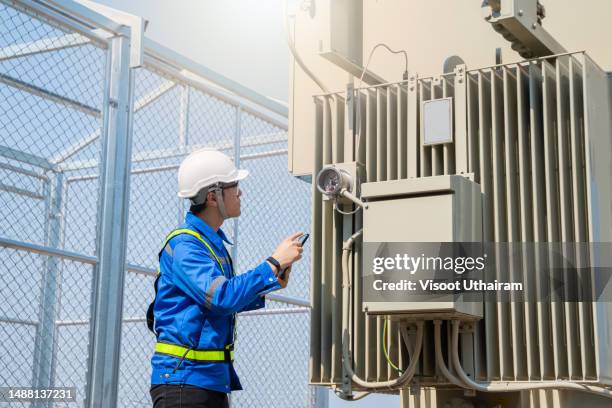 electrical engineer inspect the electrical systems at the equipment control cabinet. - generatore elettrico foto e immagini stock