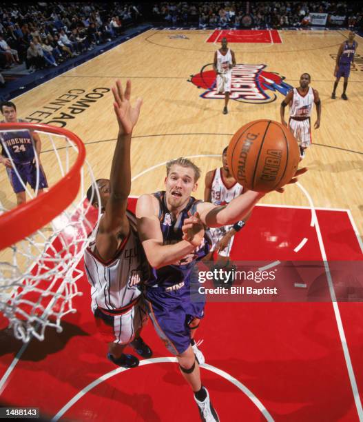 Center Jake Voskuhl of the Phoenix Suns shoots over forward Terence Morris of the Houston Rockets during the NBA game at the Compaq Center in...