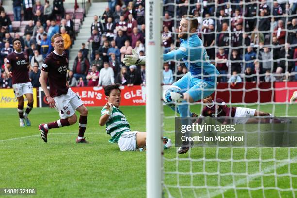 Oh Hyeon-Gyu of Celtic scores the team's second goal past Zander Clark of Heart of Midlothian during the Cinch Scottish Premiership match between...