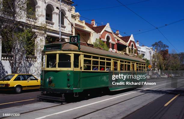 a older-style w-class tram travels along a suburban street. - w class trams stock pictures, royalty-free photos & images