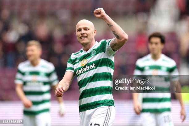 Aaron Mooy of Celtic celebrates after winning the Cinch Scottish Premiership following the match between Heart of Midlothian and Celtic FC at...