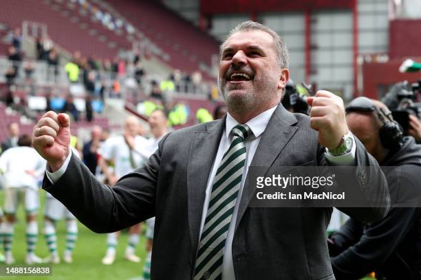 Angelos Postecoglou, Manager of Celtic, celebrates after winning the Cinch Scottish Premiership following the match between Heart of Midlothian and...
