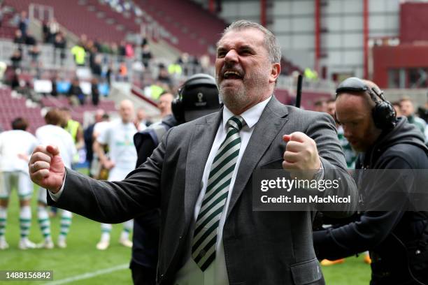 Angelos Postecoglou, Manager of Celtic, celebrates after winning the Cinch Scottish Premiership following the match between Heart of Midlothian and...