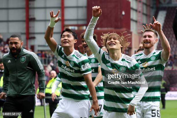 Oh Hyeon-Gyu and Kyogo Furuhashi of Celtic, celebrate after winning the Cinch Scottish Premiership following the match between Heart of Midlothian...