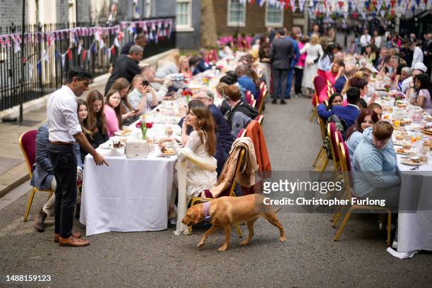 Prime Minister Rishi Sunak beckons his pet dog nova during a lunch in Downing Street to celebrate the coronation of King Charles III and Queen...